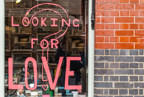 Loveandfriends window in Shoredicth with pink writing that says are you lookng for love